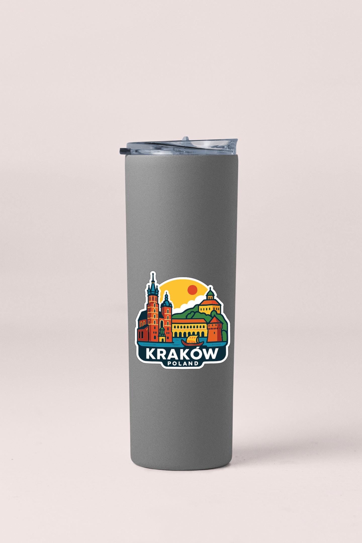 A gray insulated tumbler with a printed design of the Krakow, Poland skyline.