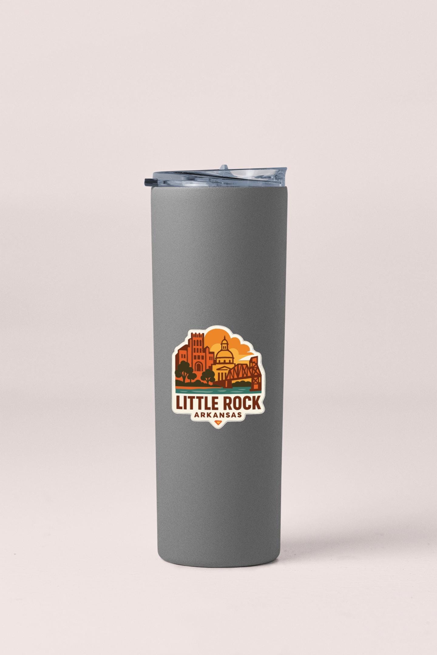 A gray insulated tumbler with a lid and a logo that says "Little Rock Arkansas".