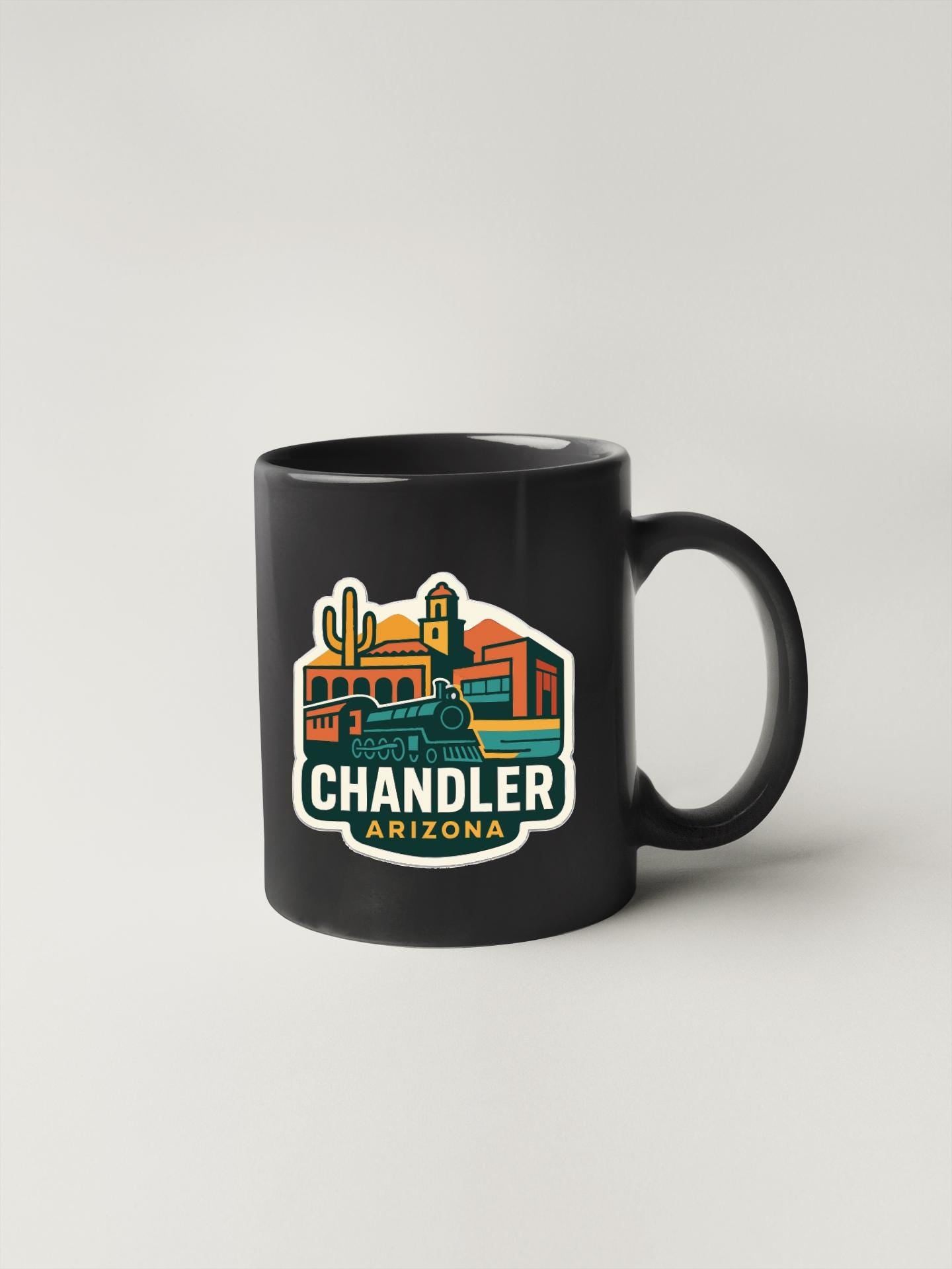 A black coffee mug with a colorful graphic design depicting the city of Chandler, Arizona.