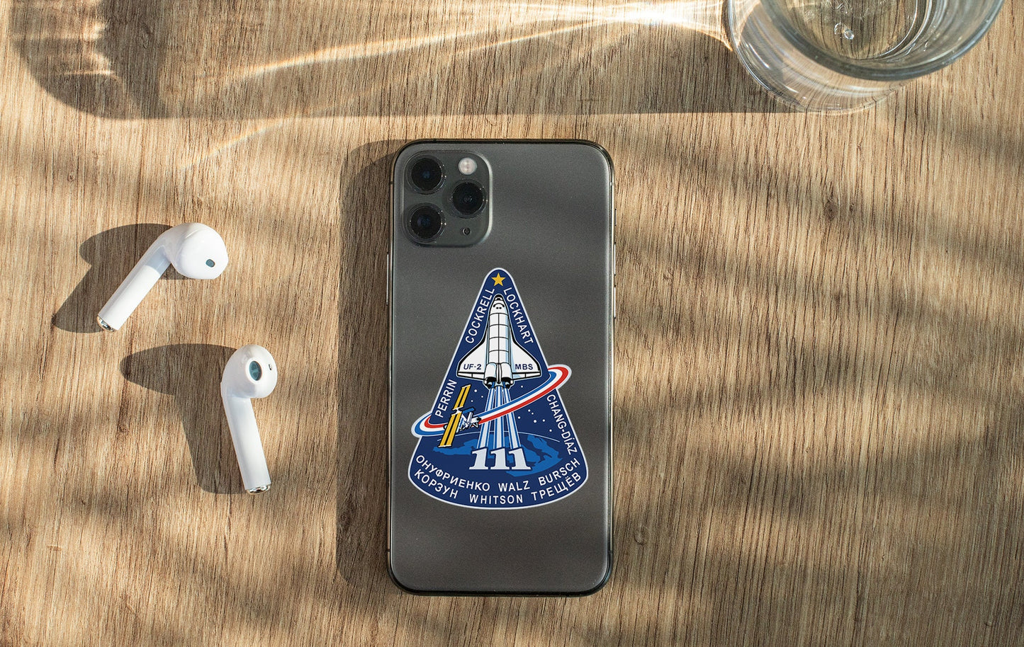 an iphone case with a space shuttle sticker on it