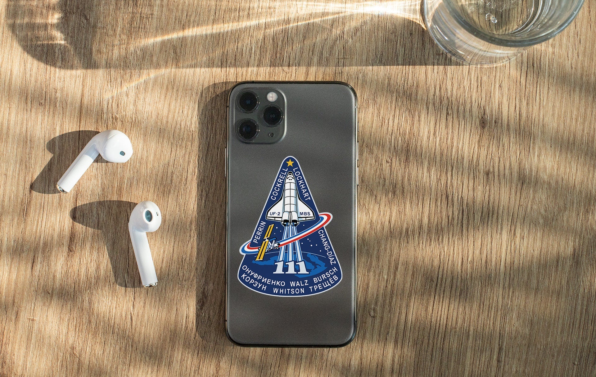 an iphone case with a space shuttle sticker on it