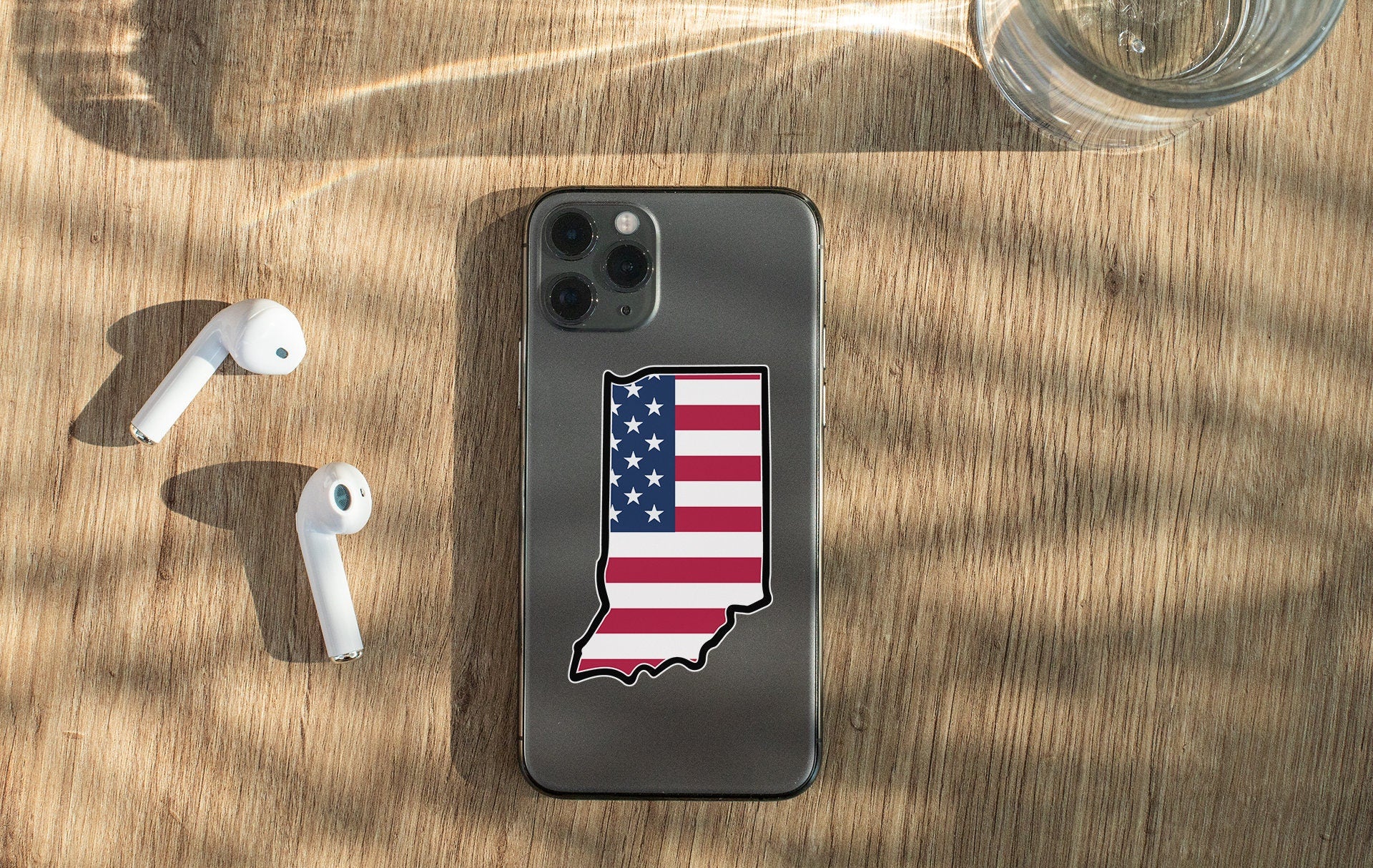 a cell phone with a sticker of the state of indiana