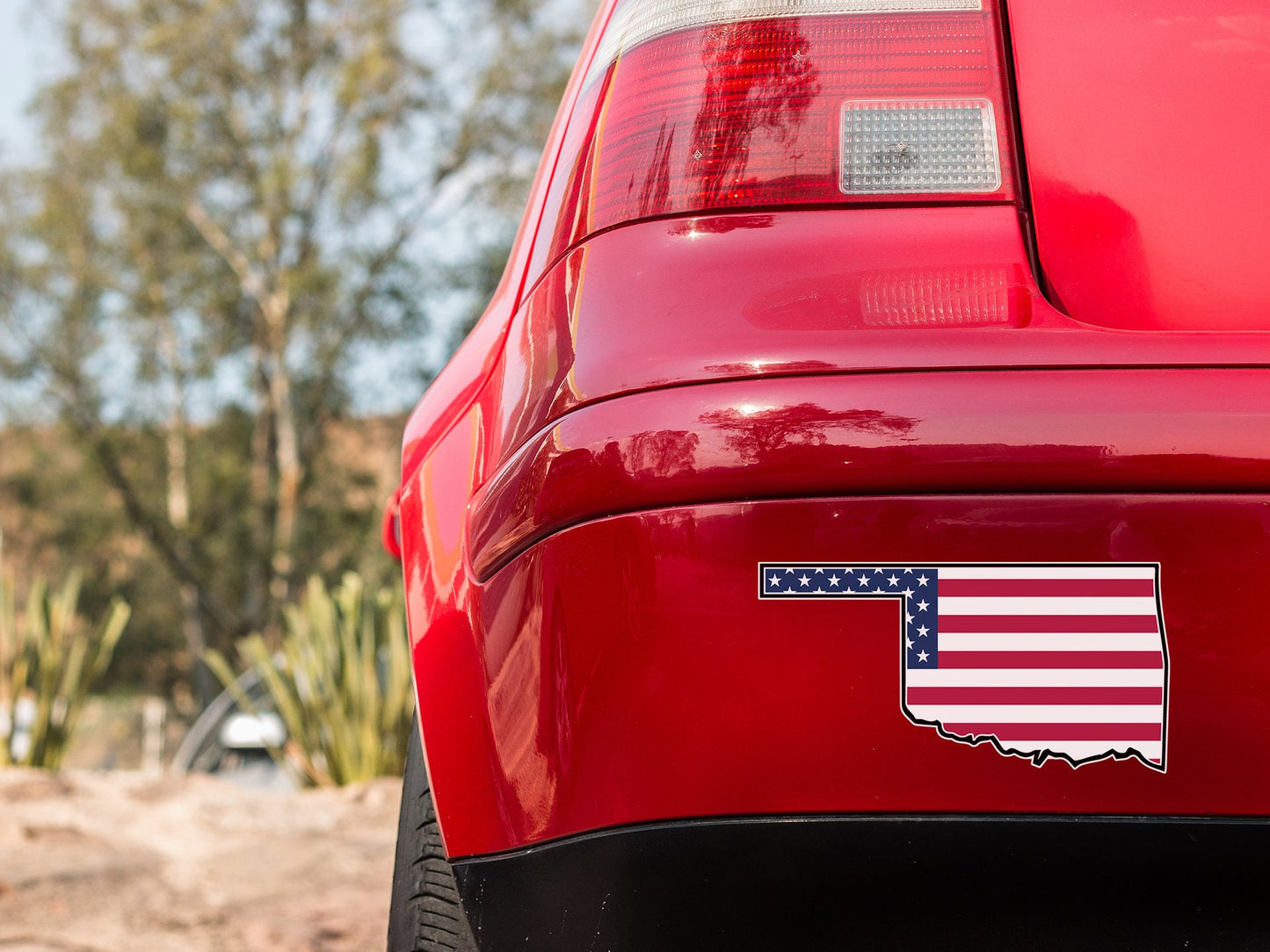 a red car with an american flag sticker on it