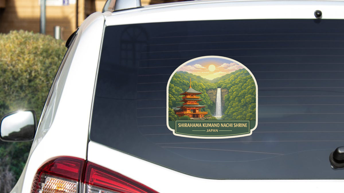 A sticker on the rear window of a car depicting a temple with a waterfall in the background.