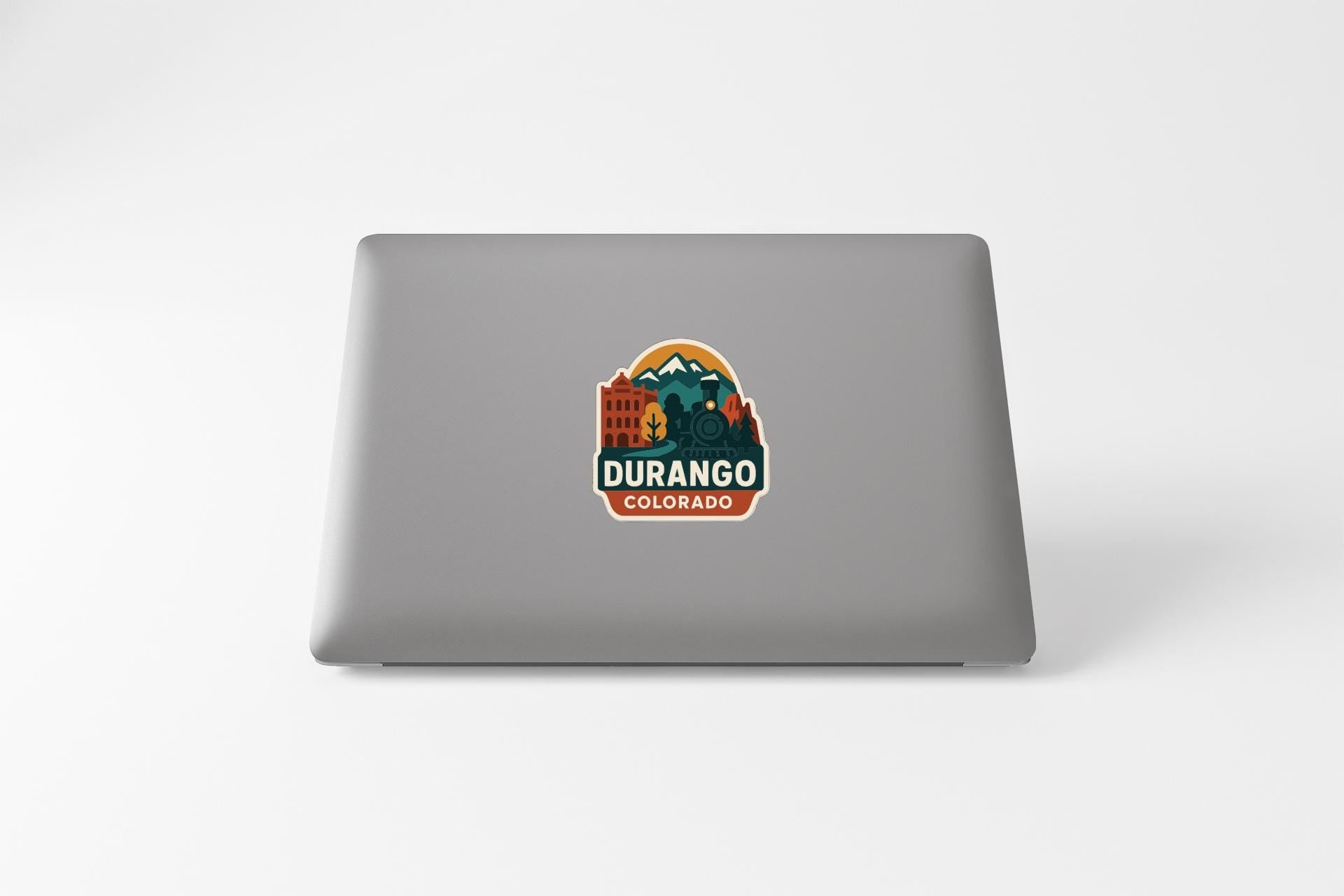 a sticker with a mountain and buildings, along with the text "DURANGO COLORADO".