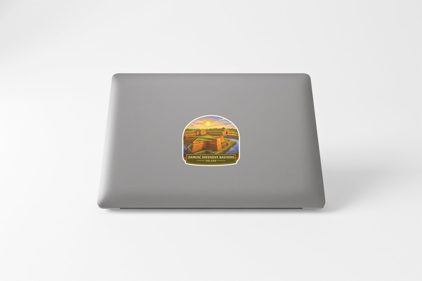 A sticker depicting a scenic landscape with a castle or fortification in the background.