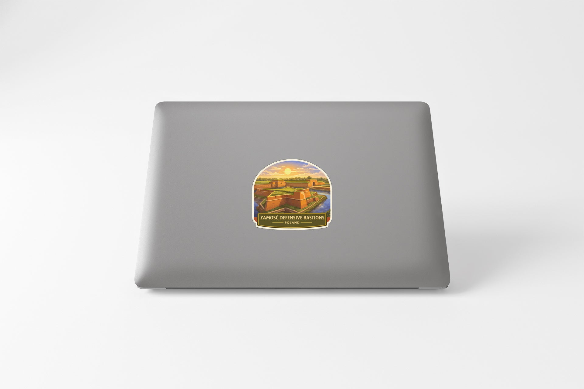 A sticker depicting a scenic landscape with a castle or fortification in the background.