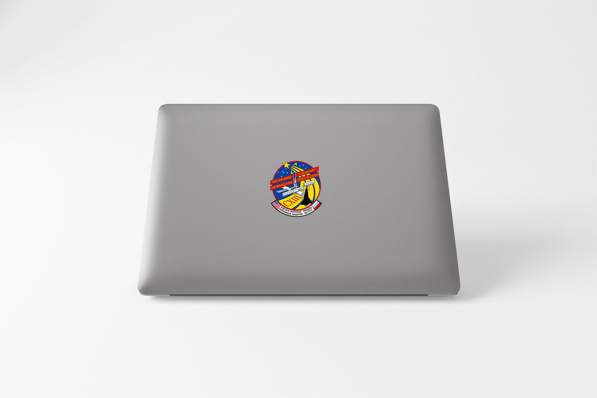 a laptop with a sticker of a man's face