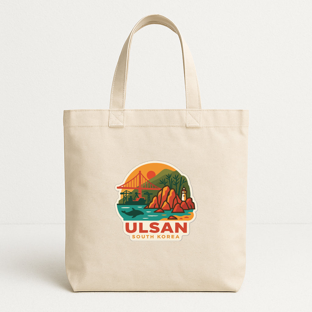 A beige tote bag with a printed design depicting a scenic landscape with a bridge, mountains, and a sunset.