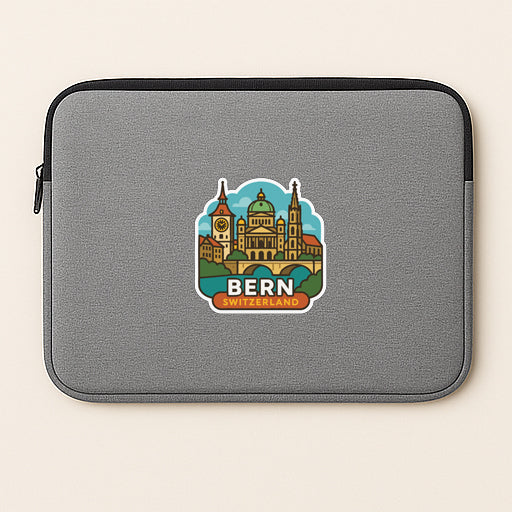 a gray laptop sleeve with a sticker depicting a city skyline, specifically Bern, Switzerland.