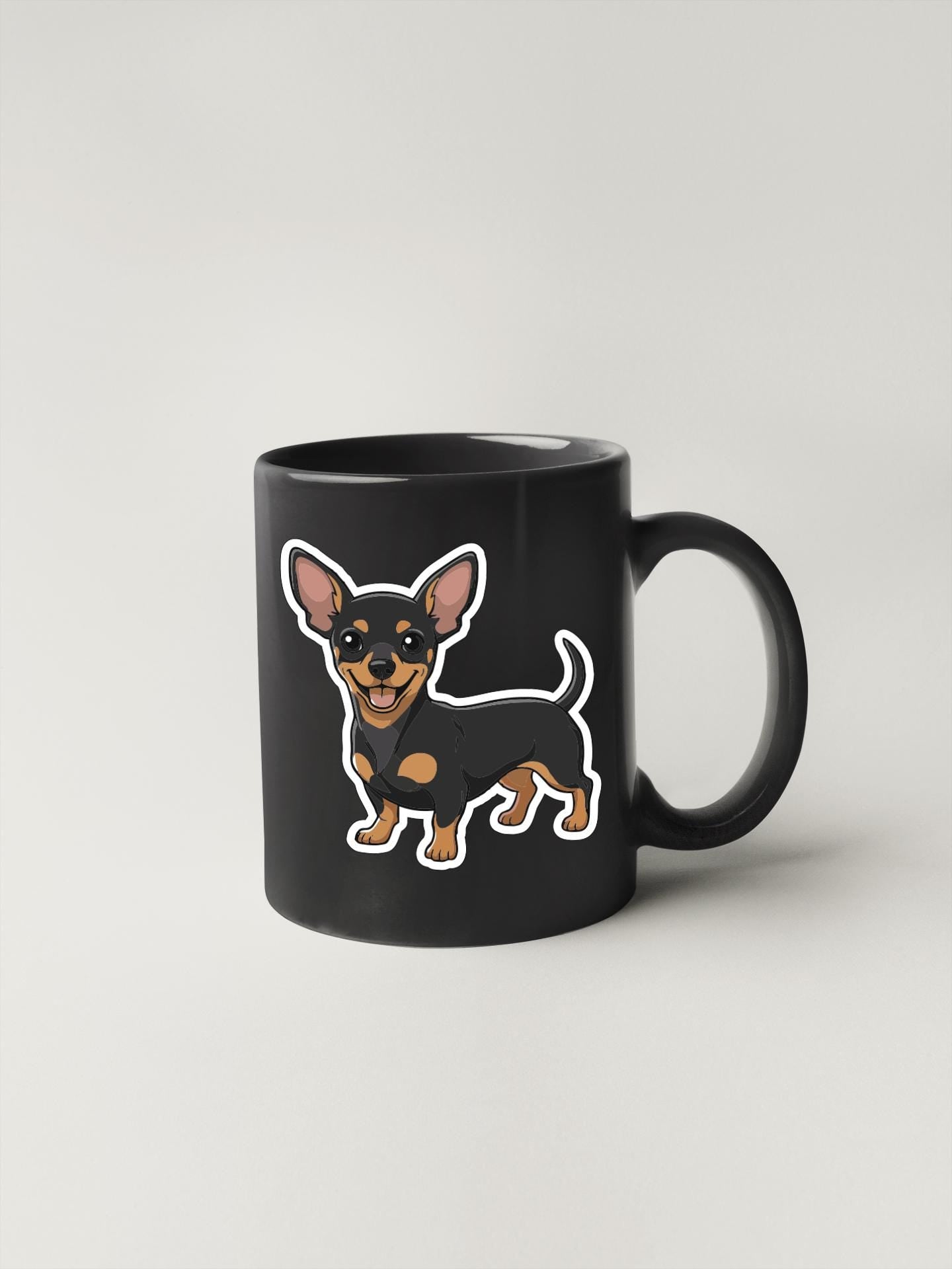 A black coffee mug with a cartoon illustration of a small dog on it.