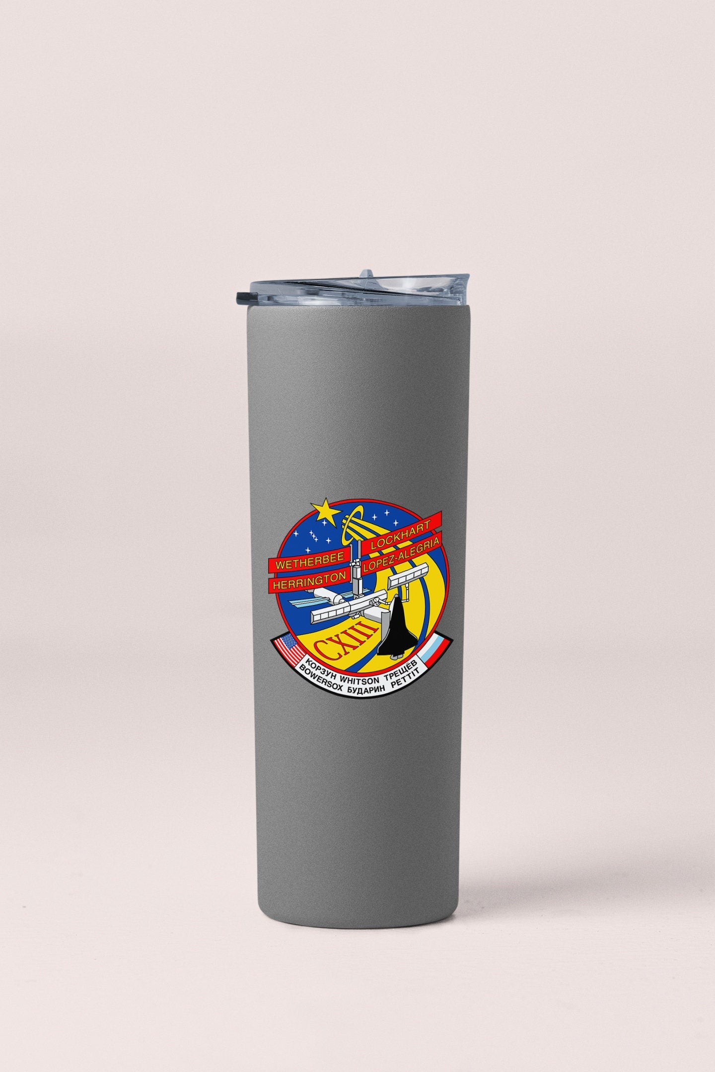 a travel mug with a picture of a bridge on it