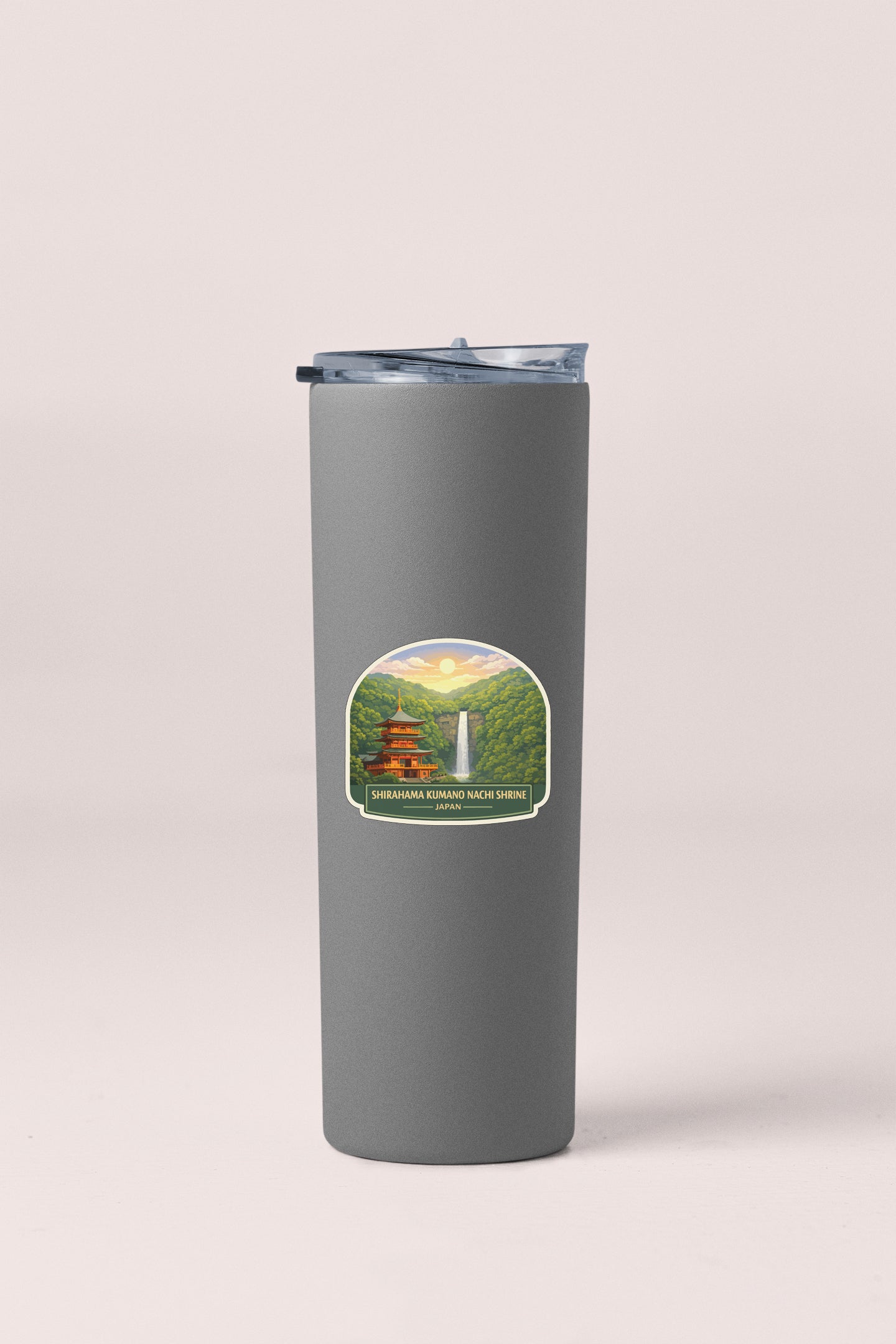 A gray insulated tumbler with a label depicting a scenic landscape featuring a waterfall and a temple.