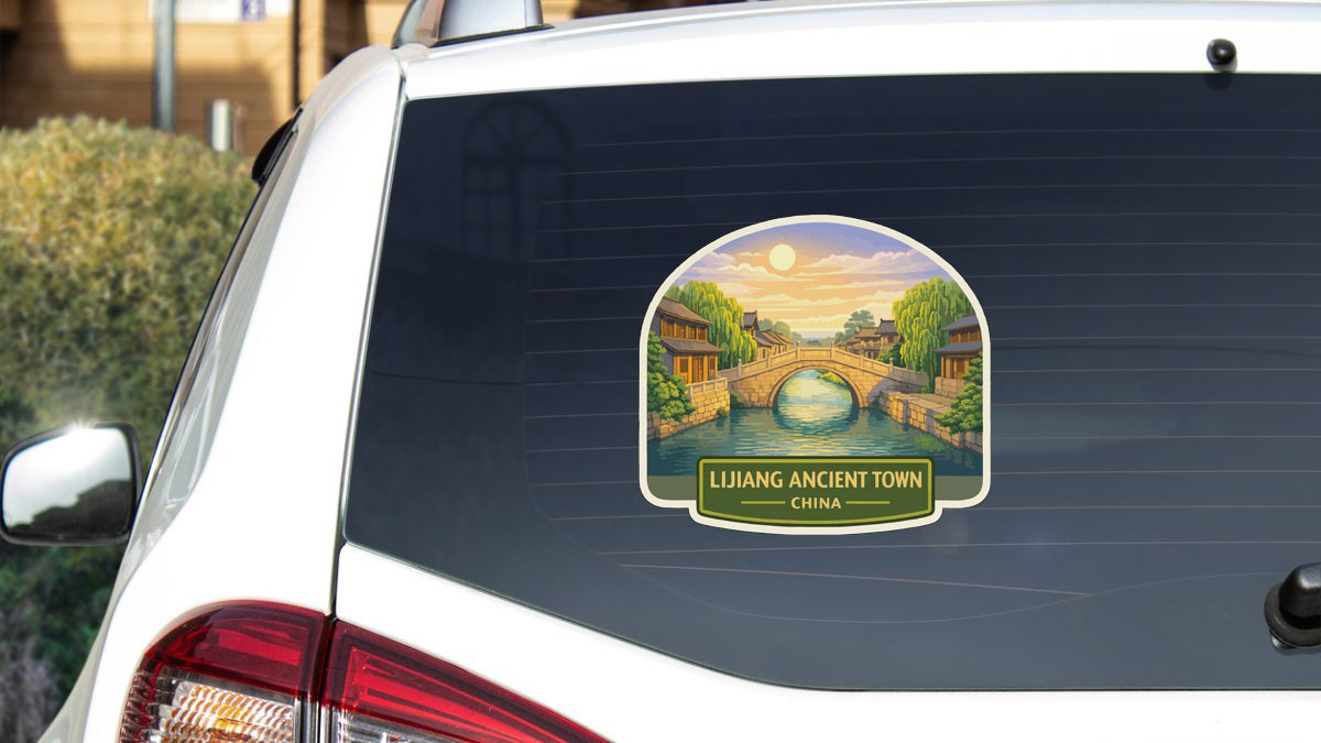 a sticker on the rear window of a car that depicts a scenic view of an ancient town in China.