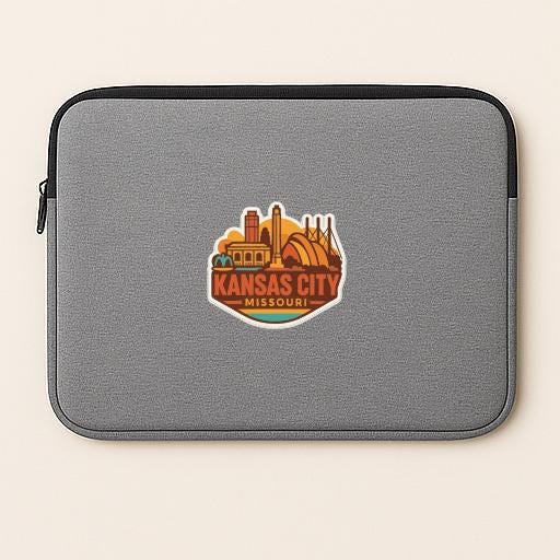A gray laptop sleeve with a sticker of the Kansas City skyline printed on it.