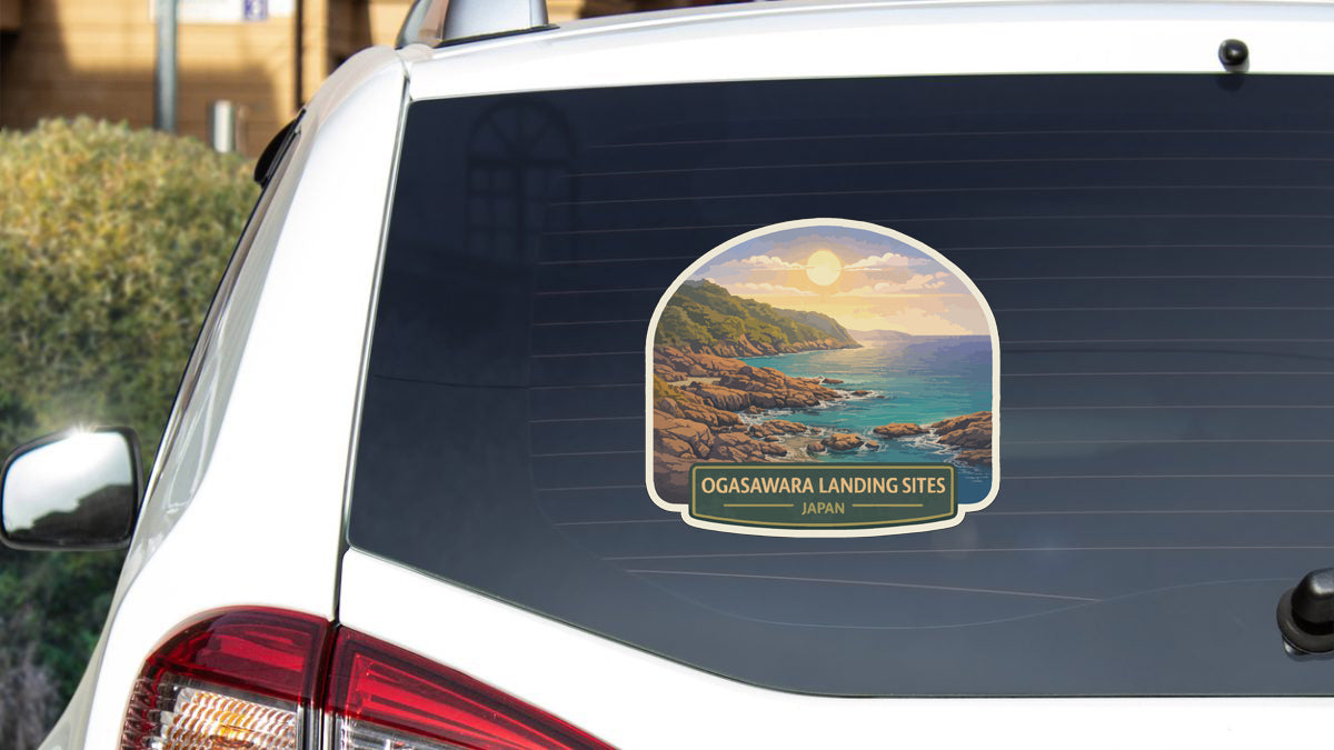 a sticker on the rear window of a white car, depicting a scenic coastal landscape with a sunset over the ocean.