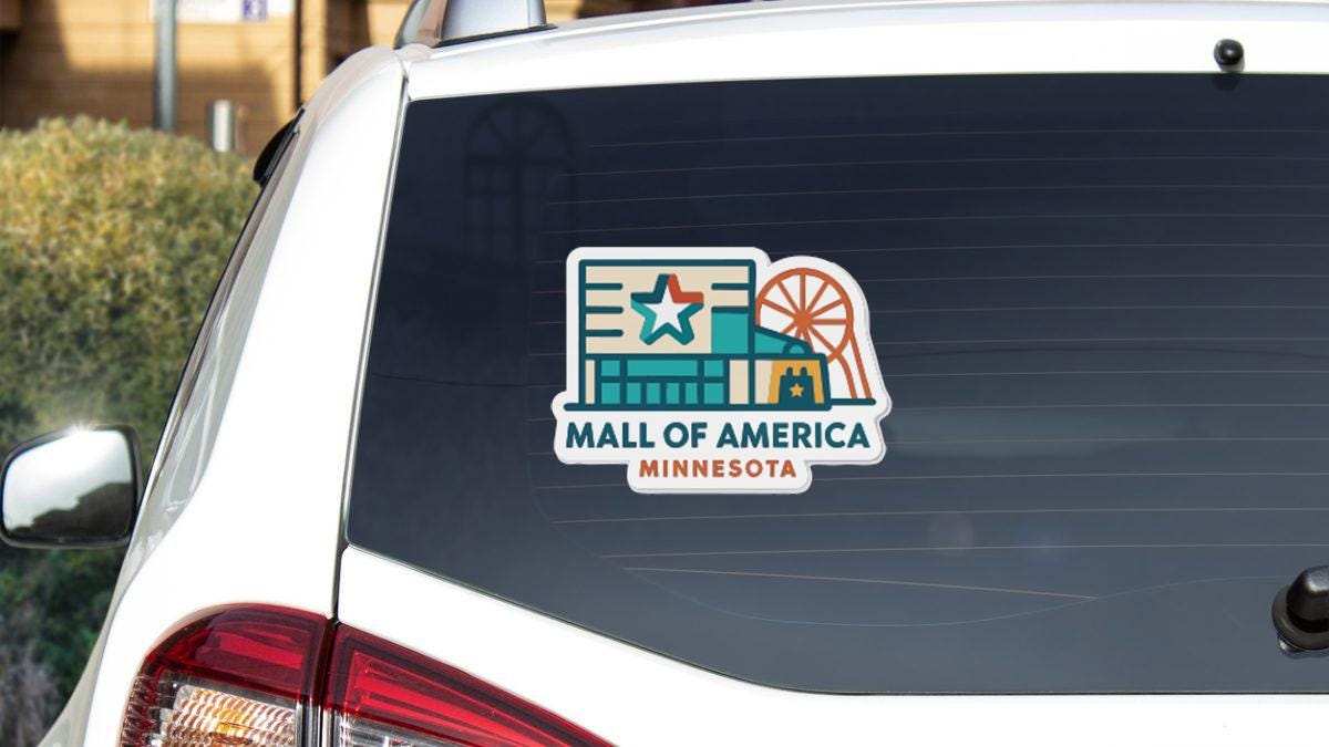 A sticker on the rear window of a vehicle that says "MALL OF AMERICA MINNESOTA".