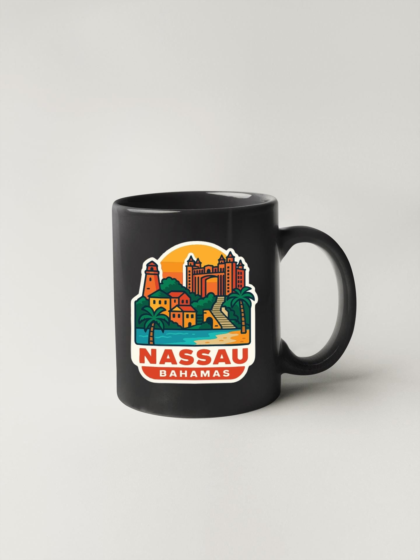 A black coffee mug with a colorful illustration of a tropical island and buildings, along with the text "NASSAU DHAAMAS".