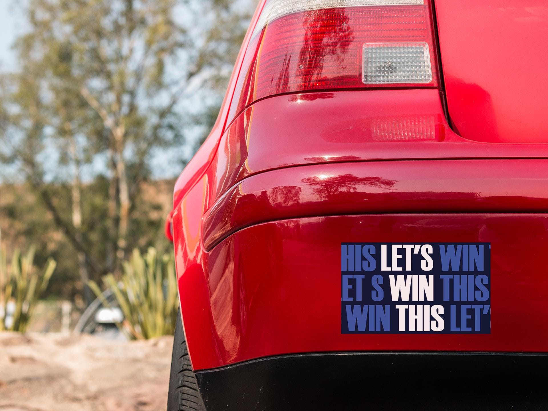 a red car with a blue sticker on it