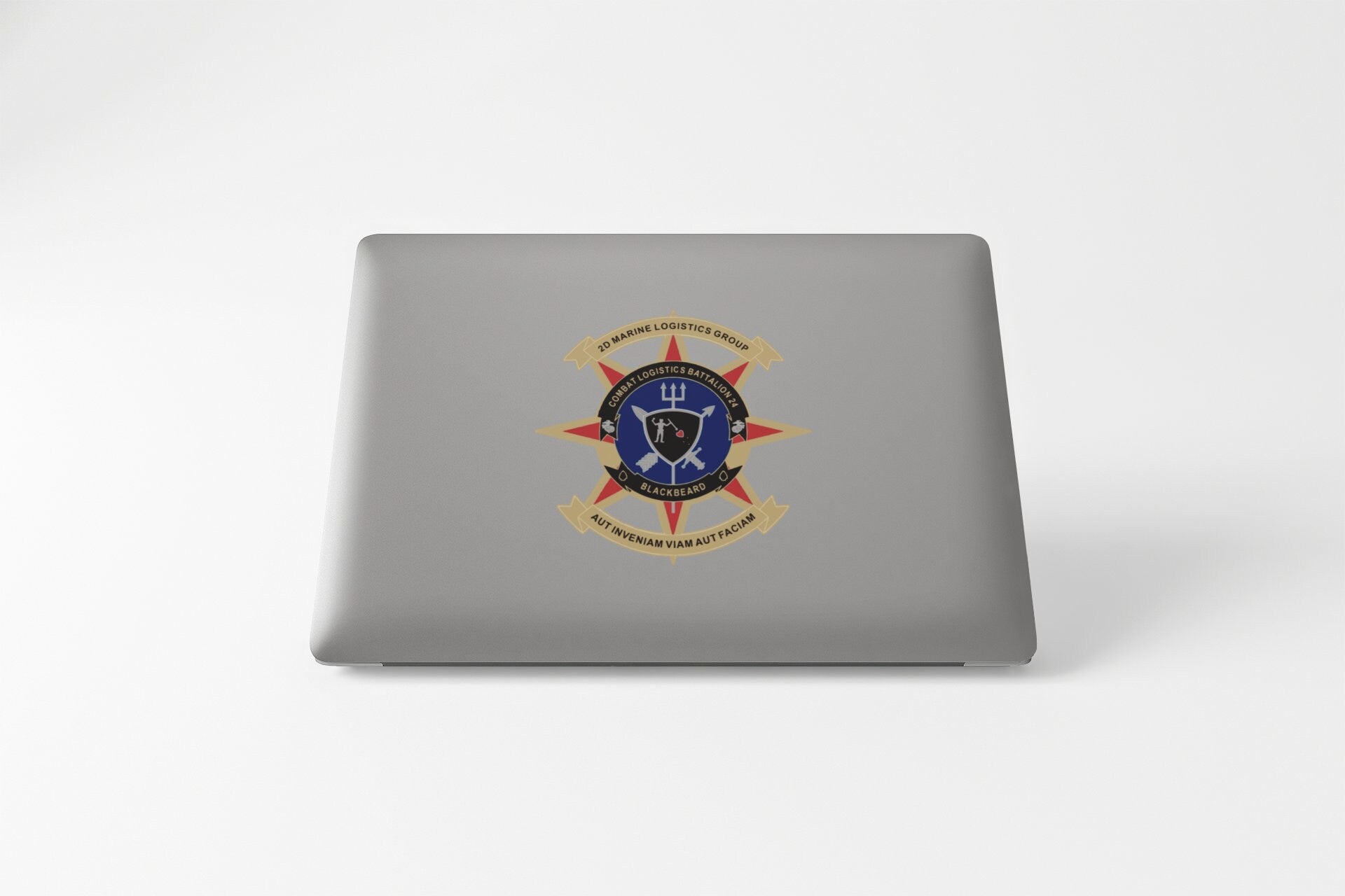 a laptop with a picture of a shield and swords on it