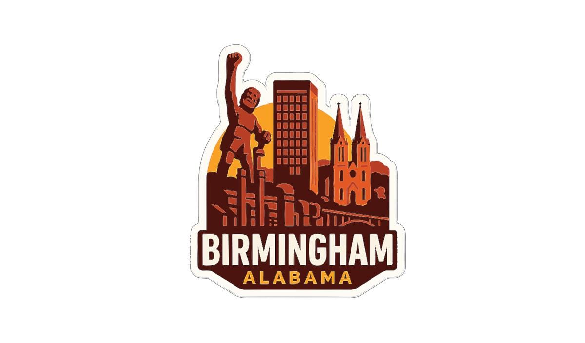 A sticker or emblem featuring the skyline of Birmingham, Alabama, with a large statue of a person raised in the air.