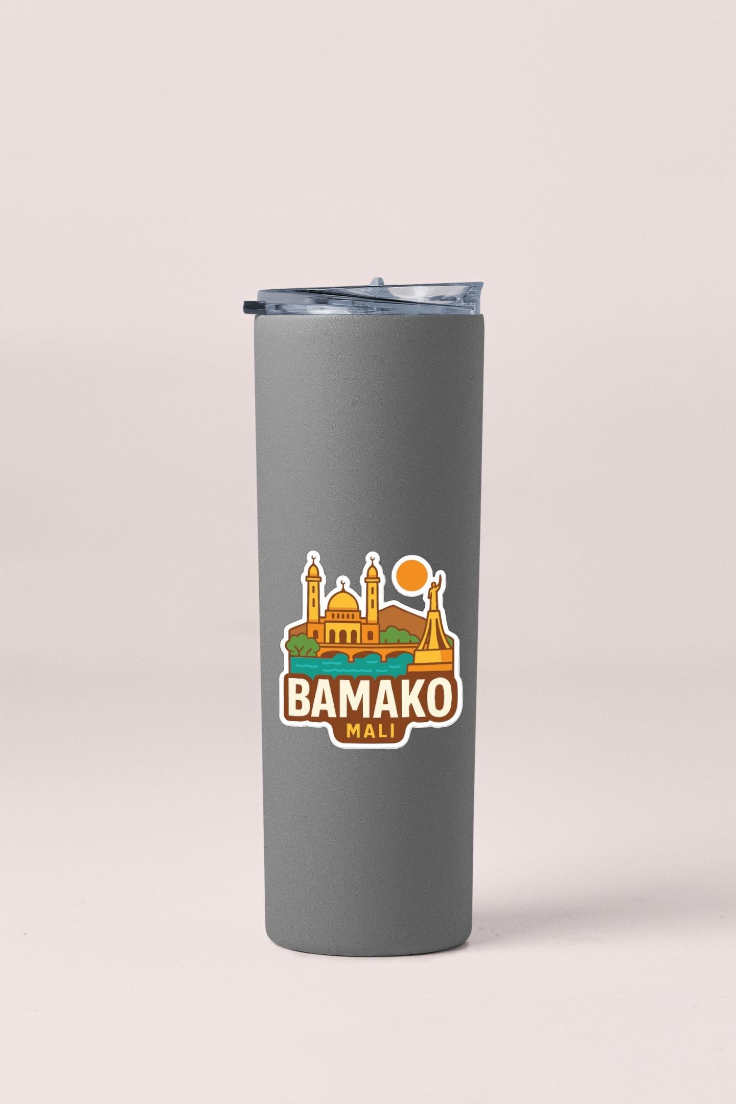 A gray insulated tumbler with a sticker depicting a city skyline and the text "BAMAKO MALI".