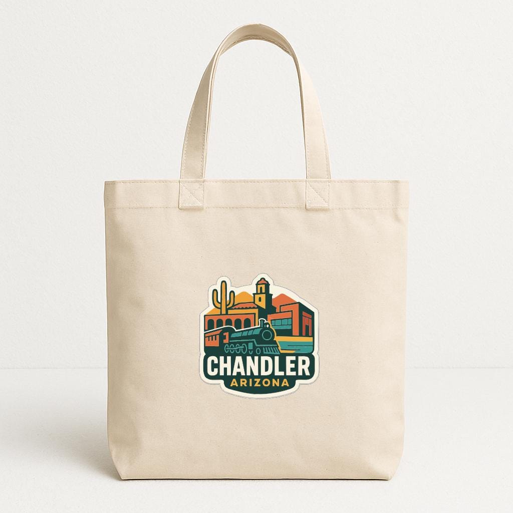 A beige tote bag with a printed design depicting a cityscape and the text "CHANDLER ARIZONA" printed on it.