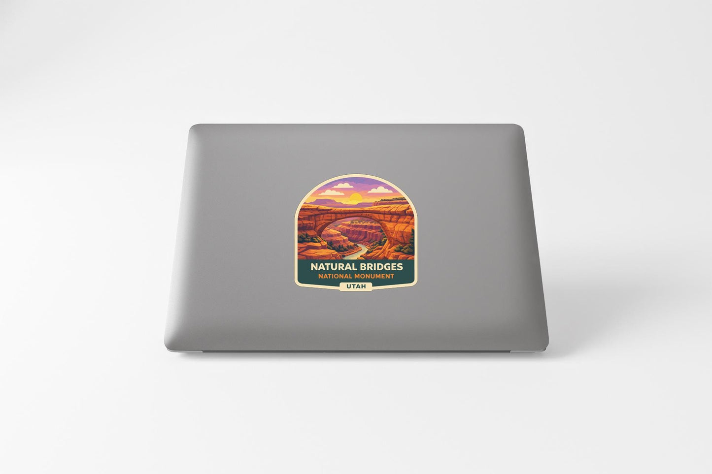 a sticker or label with a scenic landscape depicting a natural bridge, likely representing the Natural Bridges of Utah.