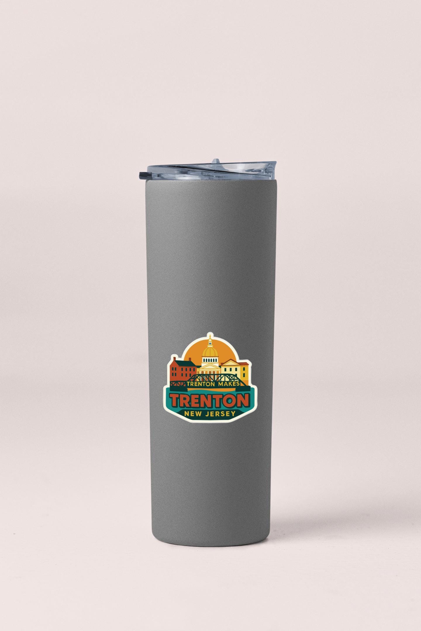 A gray insulated tumbler with a printed logo on it.