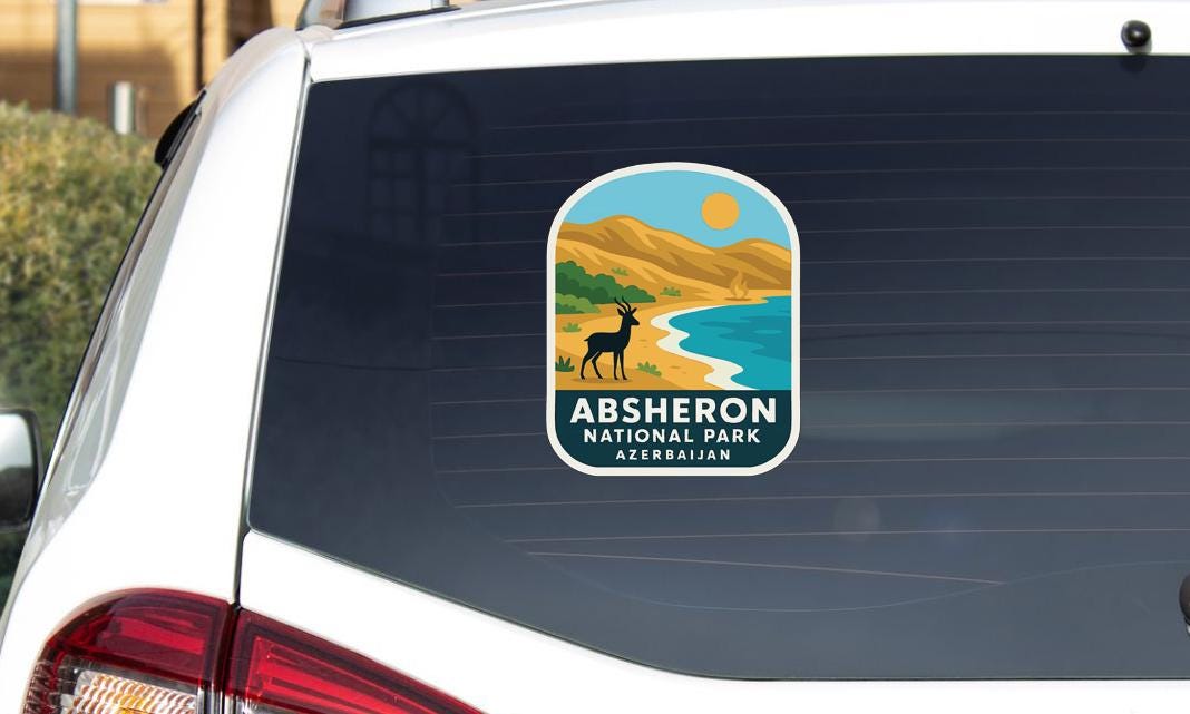 a sticker on the rear window of a vehicle, depicting a scenic landscape with mountains, a river, and a gazelle.