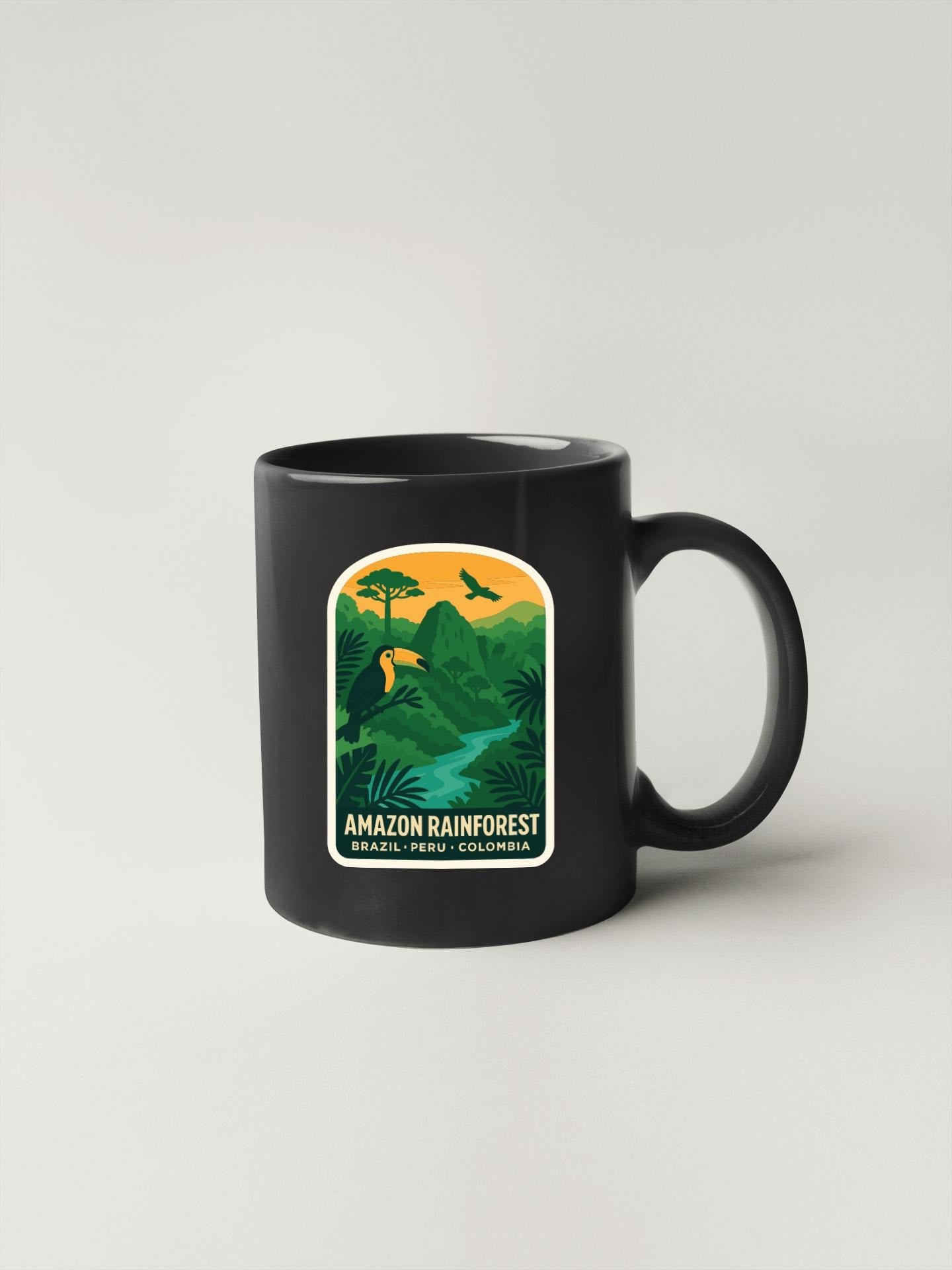 A black coffee mug with a graphic design depicting an Amazon rainforest landscape.