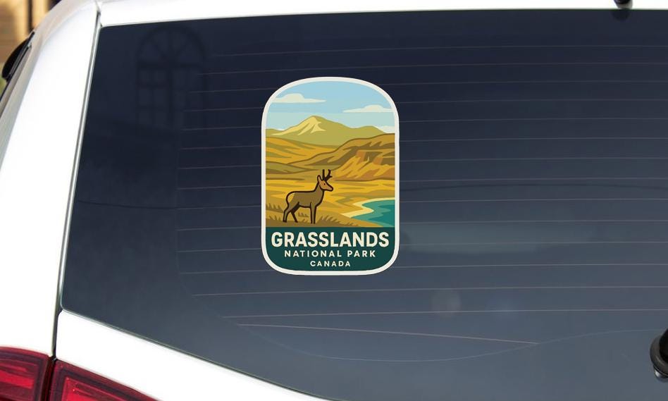A sticker on the rear window of a vehicle that says "Grasslands National Park Canada".