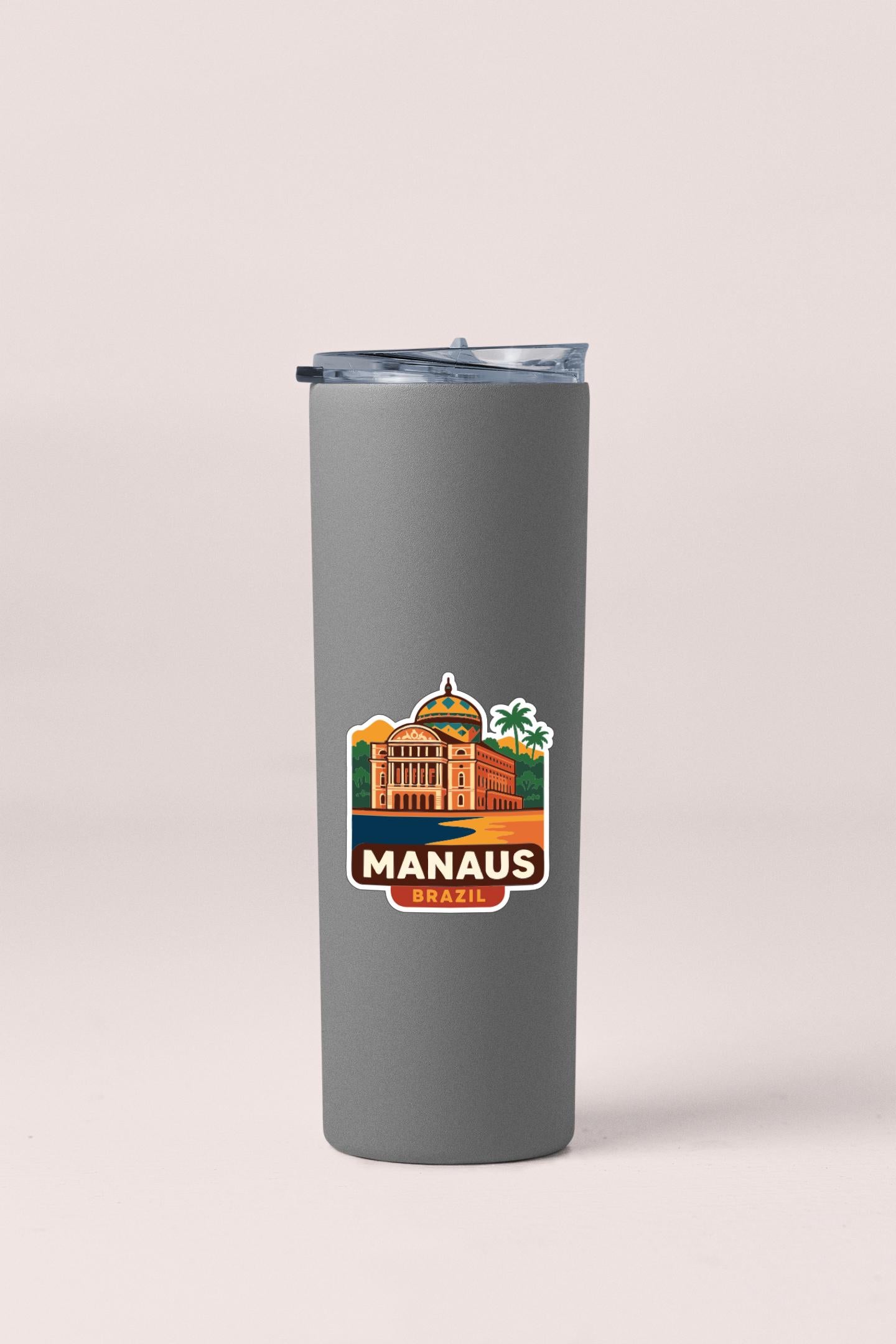 A gray insulated tumbler with a printed label depicting the Manaus, Brazil, cityscape.