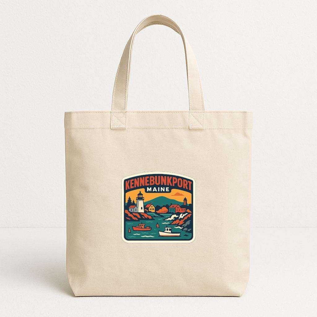 A beige tote bag with a printed design depicting a scenic view of the town of Kennebunkport, Maine.
