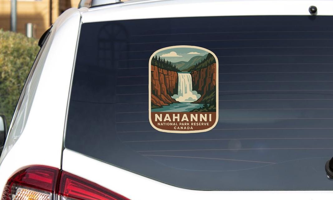 A sticker on the rear window of a vehicle that says "NAHANNI NATIONAL PARK RESERVE CANADA".