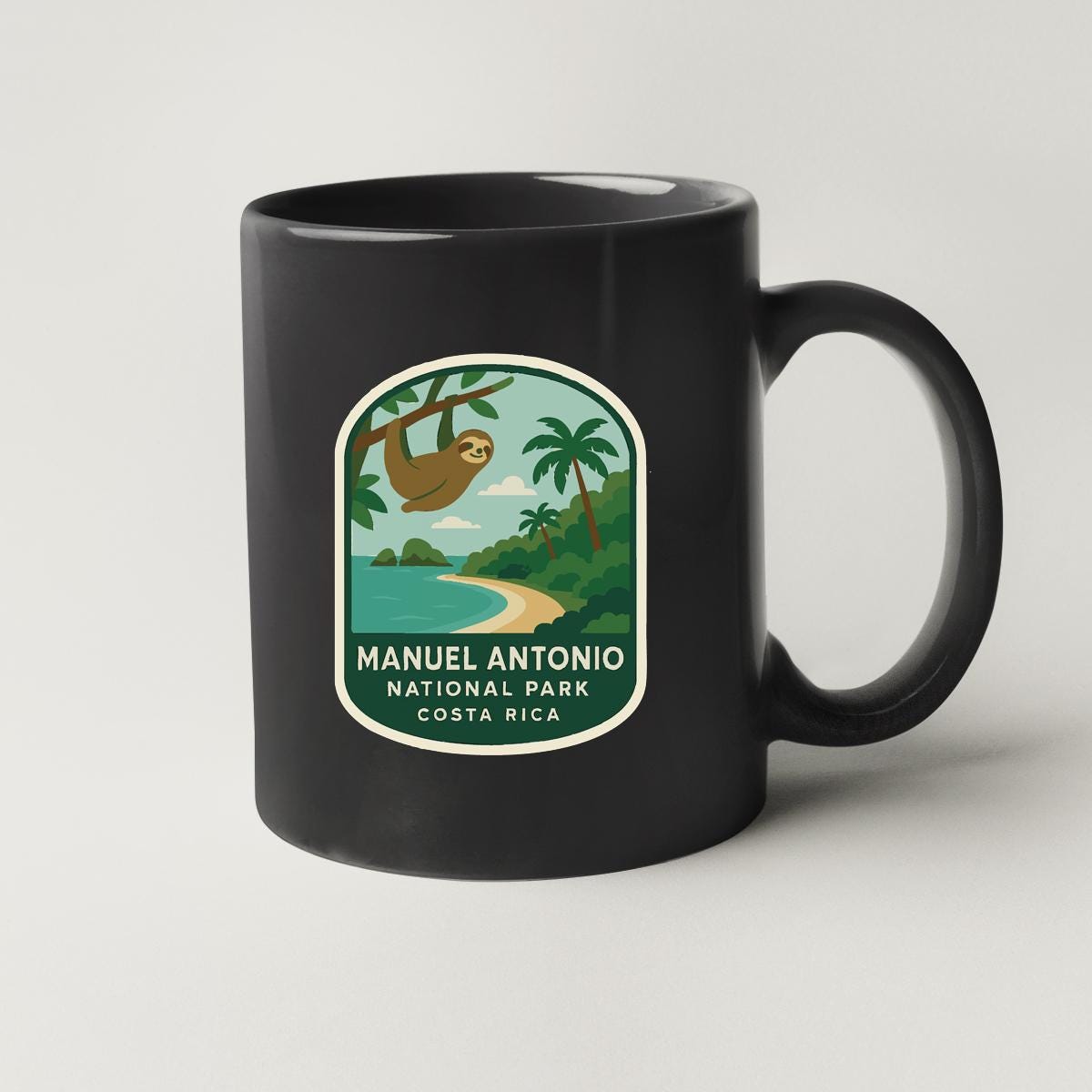 A black coffee mug with a label that says "Manuel Antonio National Park Costa Rica".