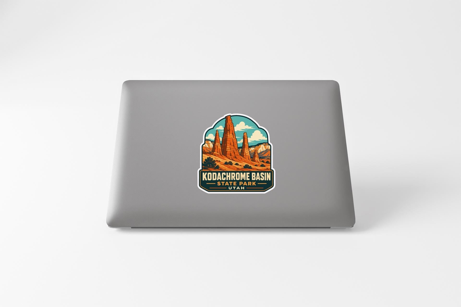 A sticker depicting the Kodachrome Basin in Utah, featuring a desert landscape with mountains and rock formations.