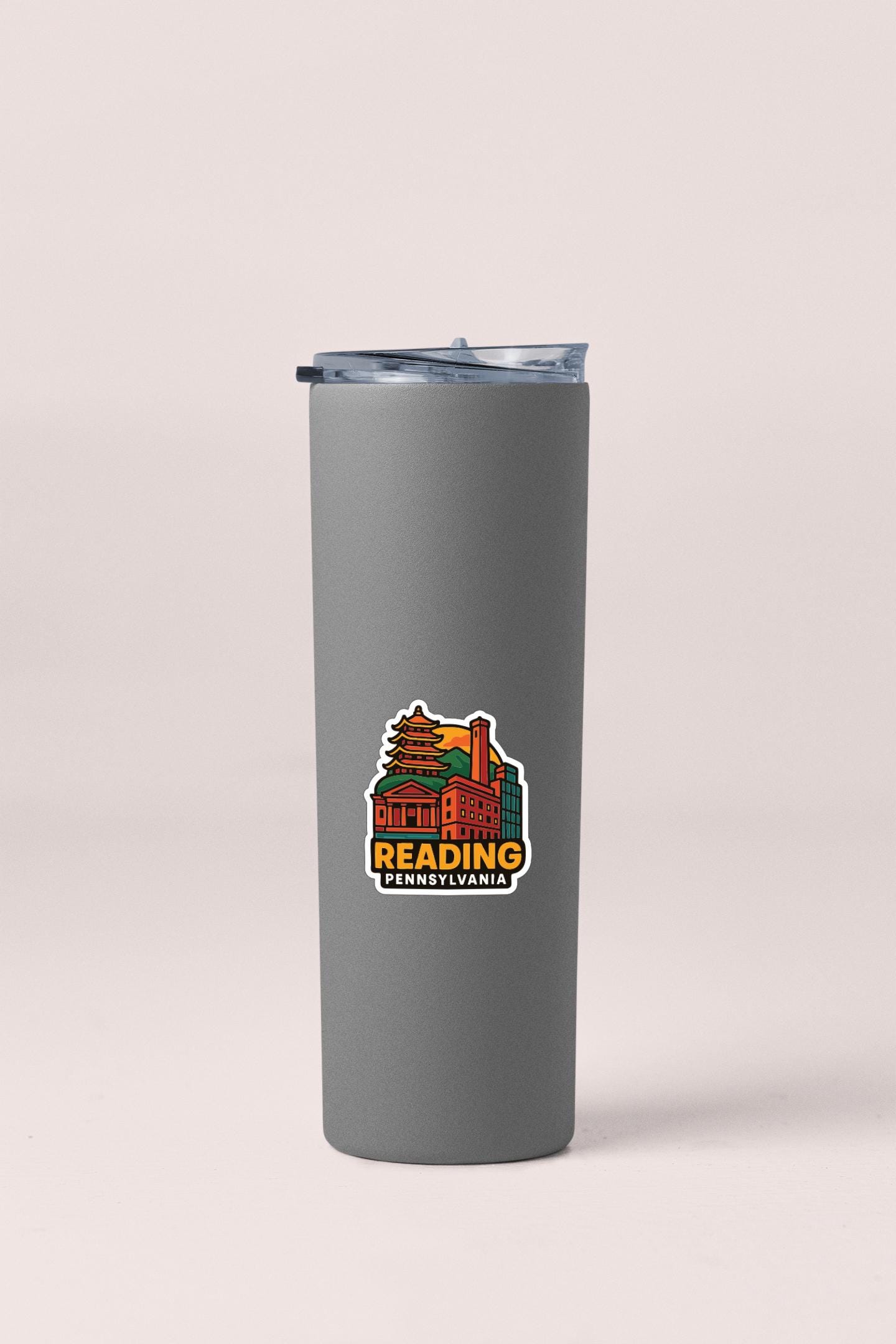 A gray insulated tumbler with a printed logo on it.