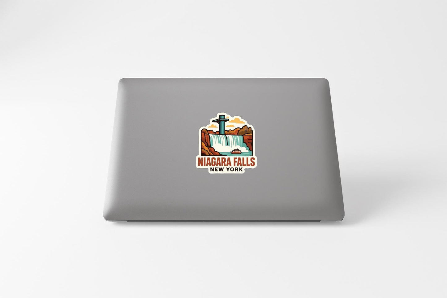 A sticker on the back of a laptop that features an illustration of Niagara Falls, New York.