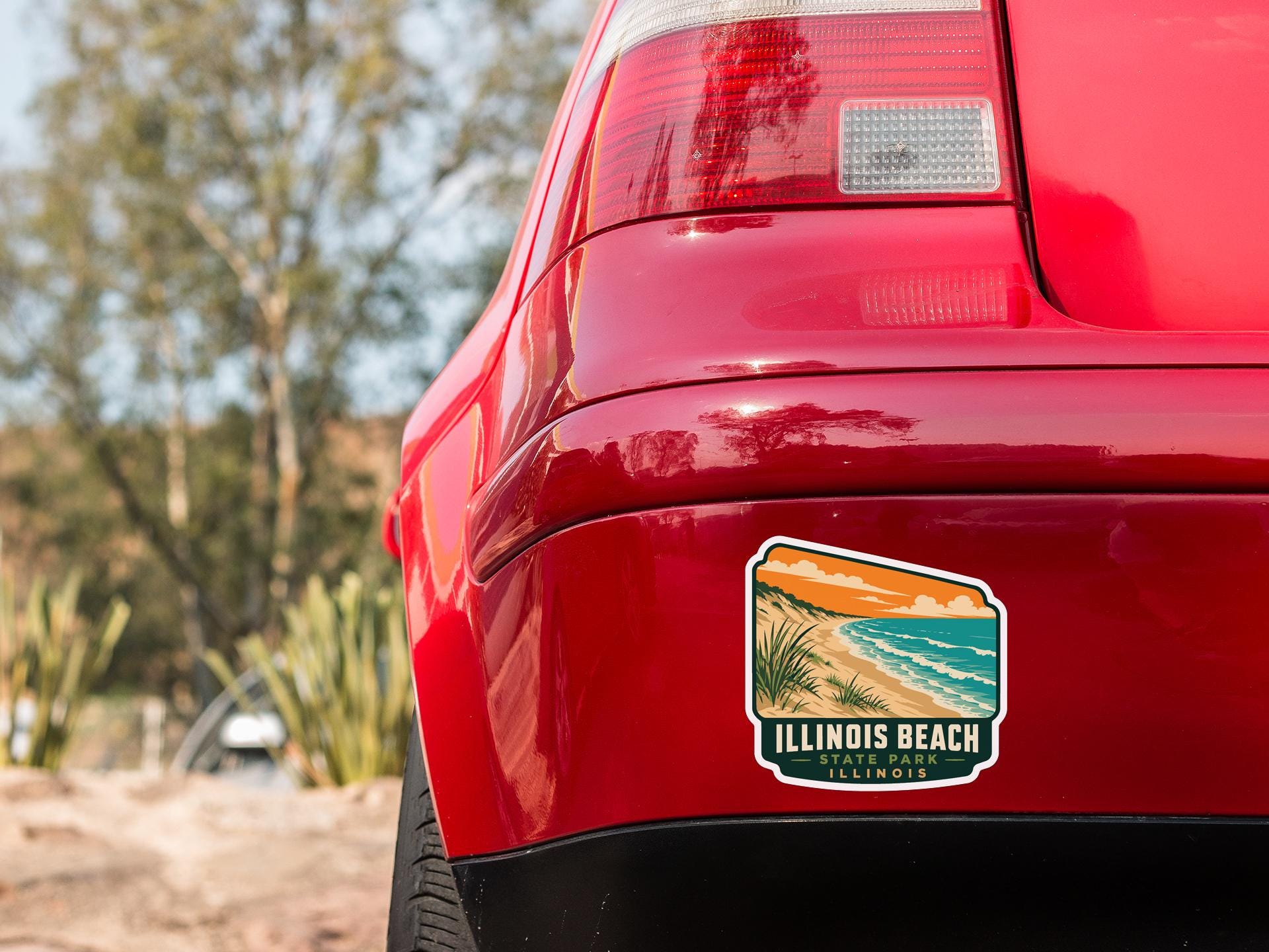 the rear end of a red car with a sticker on the back window that says "ILLINOIS BEACH, ILLINOIS".