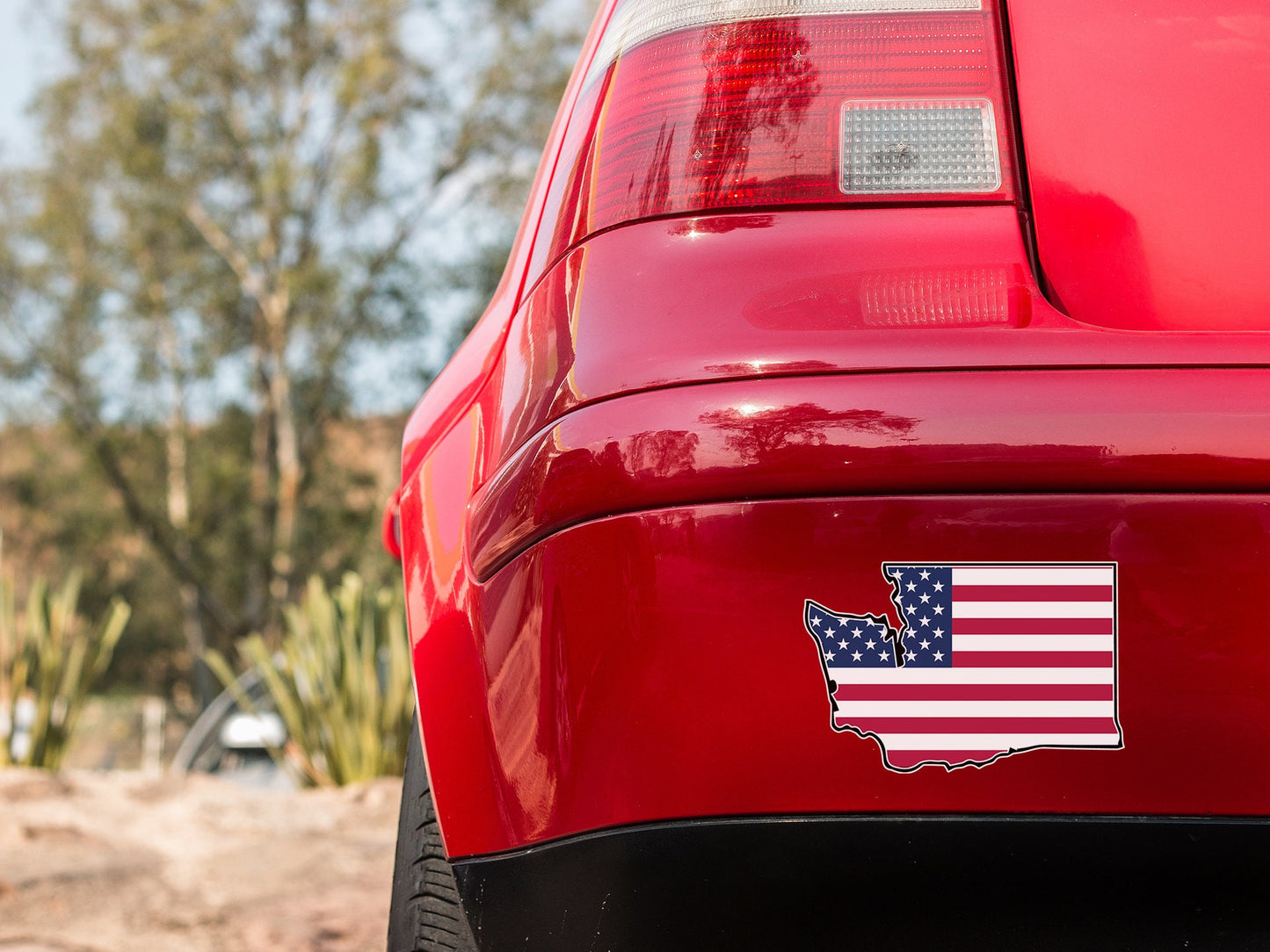 a red car with an american flag sticker on it
