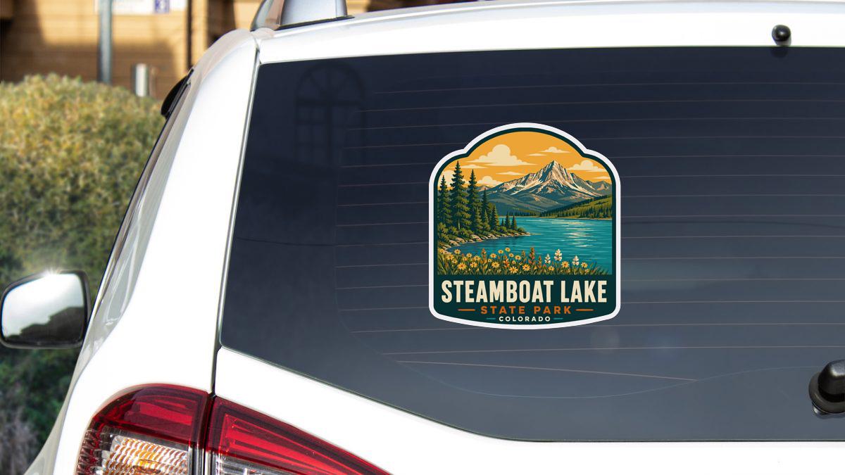 A sticker on the rear window of a car that says "Steamboat Lake State Park, Colorado".