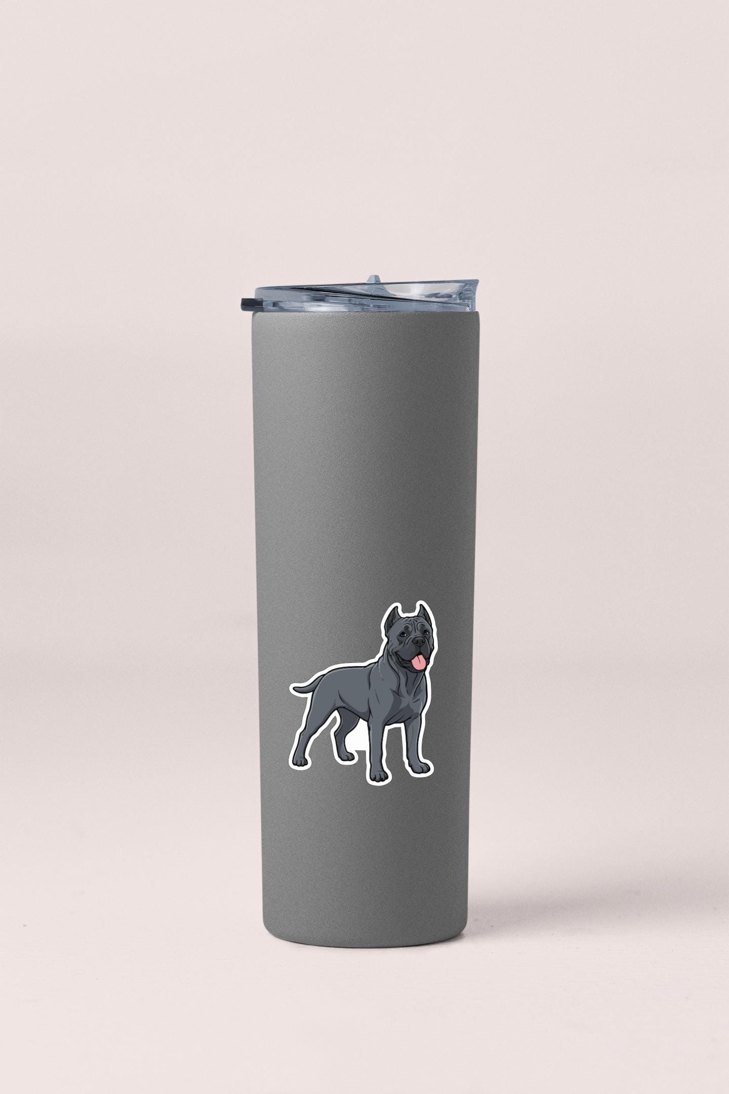 A gray tumbler with a sticker of a dog on it.