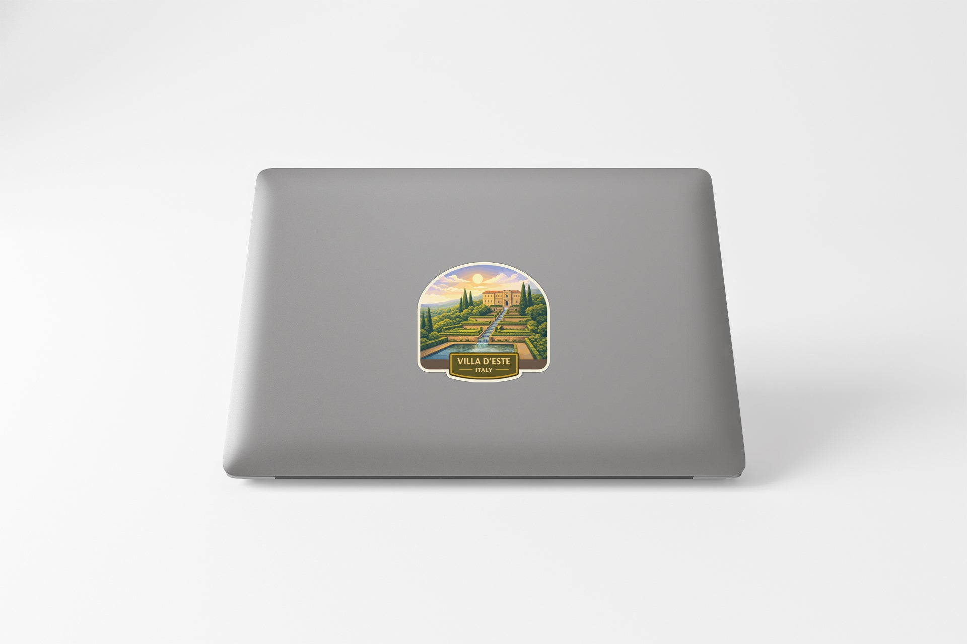 a sticker on the back of a laptop, depicting a scenic landscape with a building and trees.