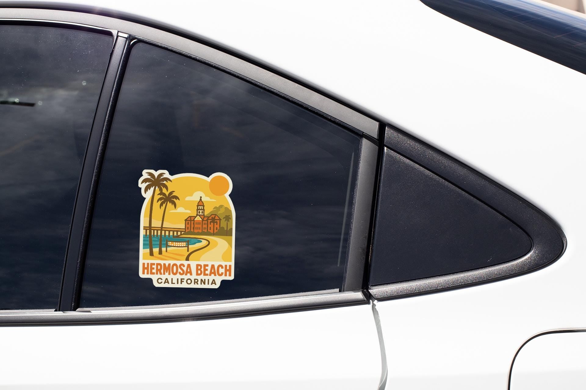 A sticker on the side of a car window, depicting a scenic view of Hermosa Beach, California.