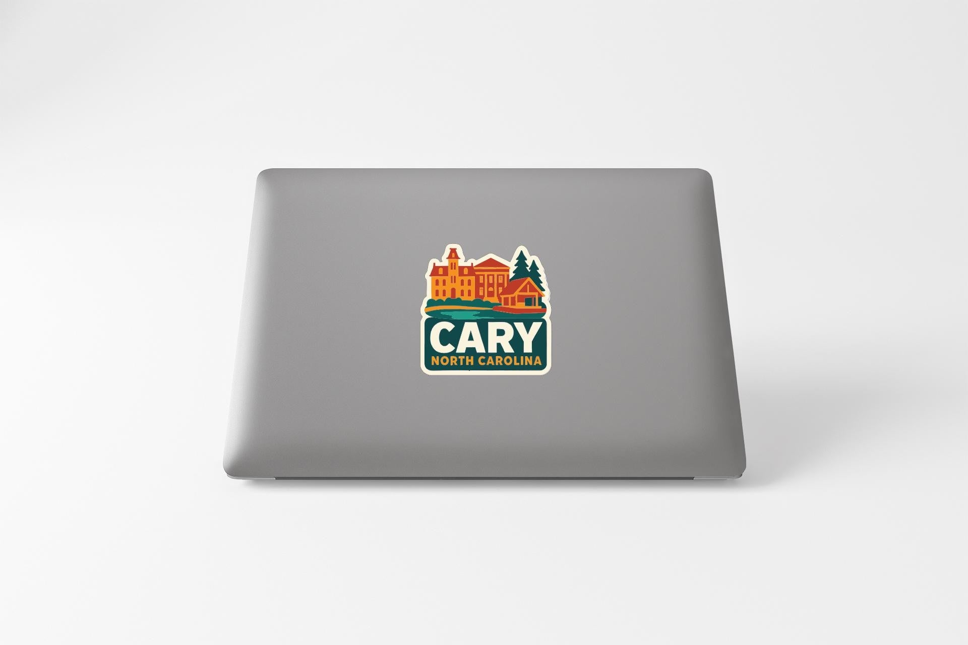 a sticker with a graphic of a building and trees, along with the text "CARY NORTH CAROLINA" printed on it.