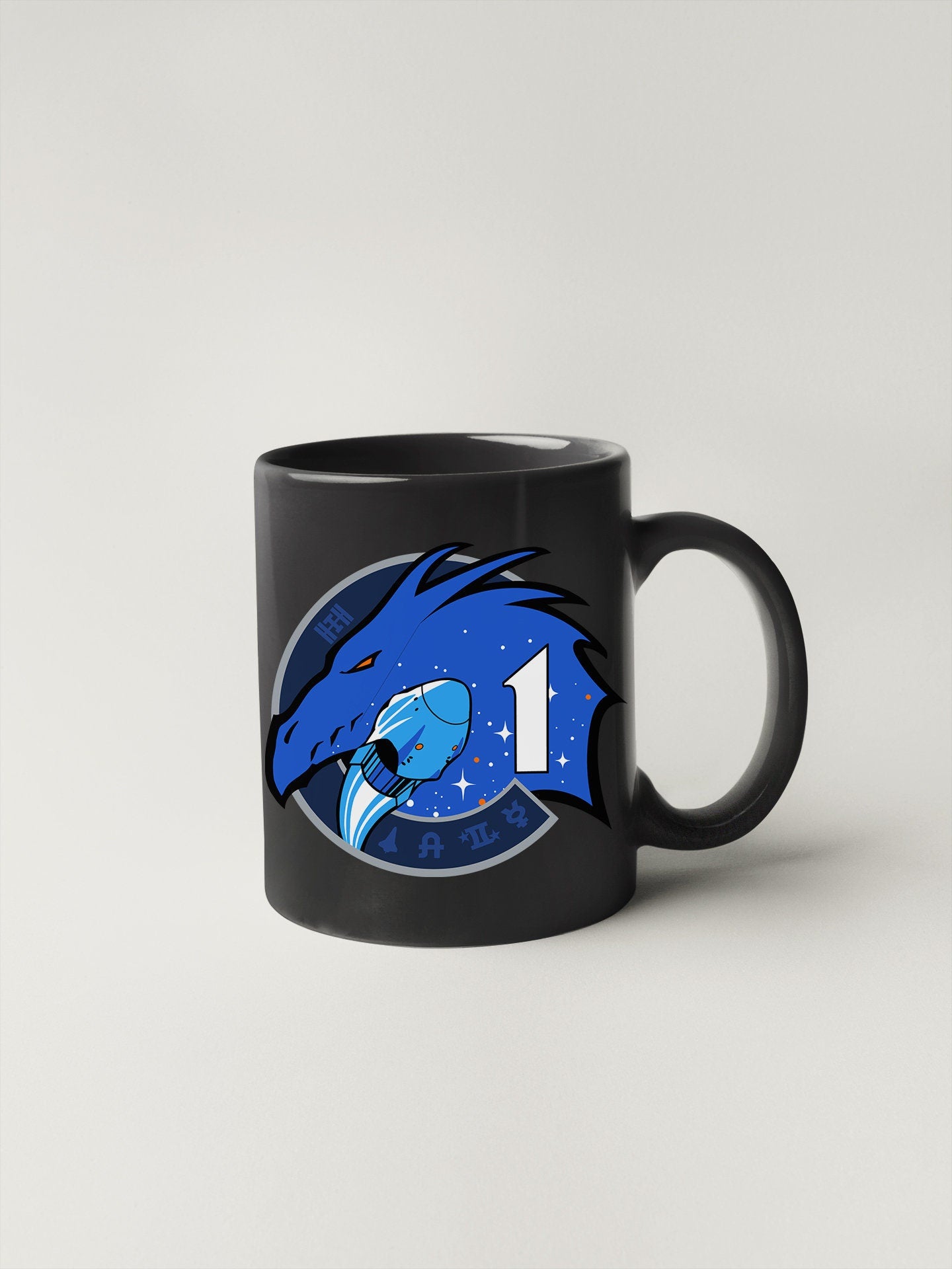 a black coffee mug with a blue dragon on it