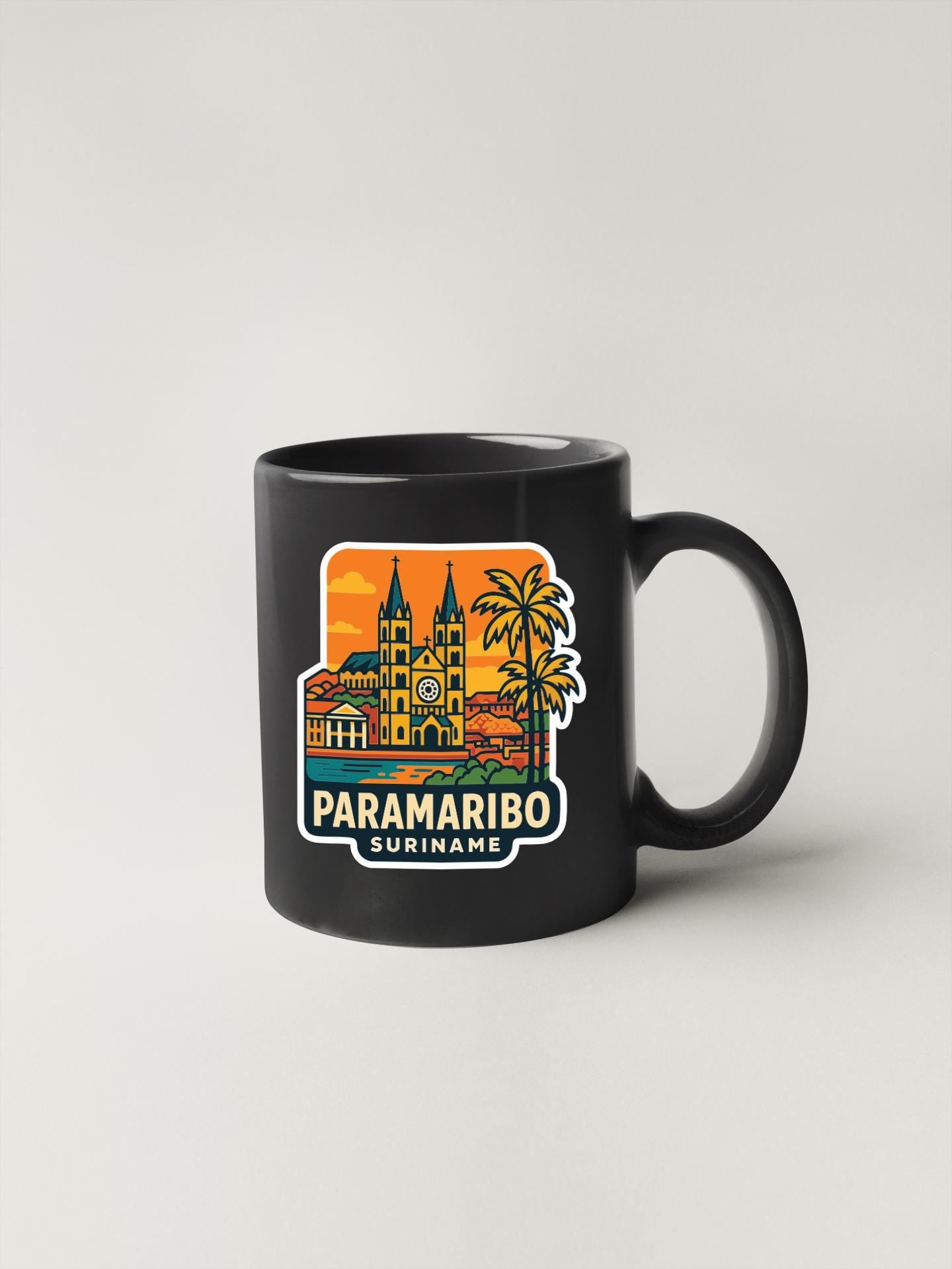A black coffee mug with a colorful illustration of a city skyline and palm trees, along with the text "PARAMARIO SURINAME".