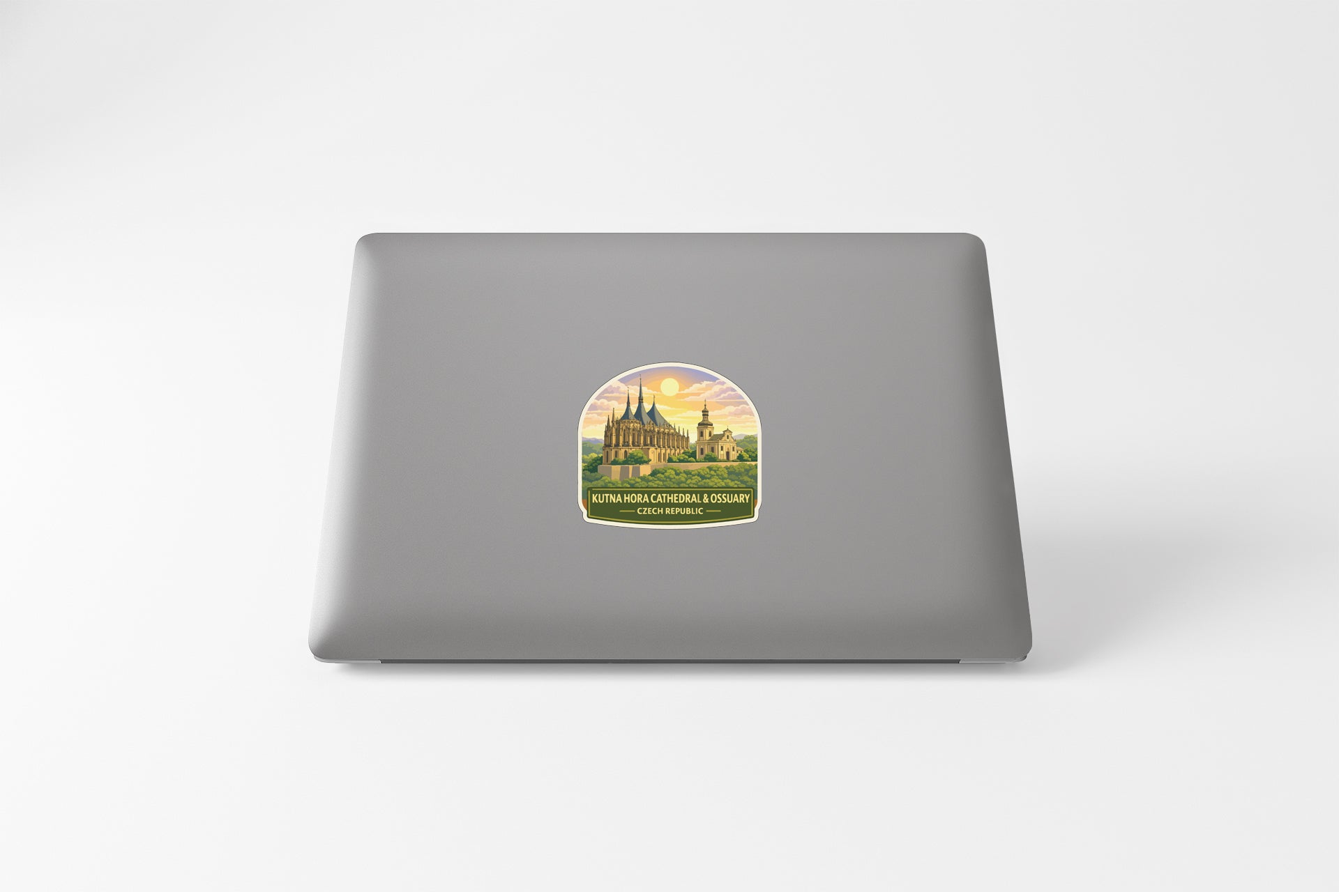 a sticker with a castle and a sunset on a laptop.