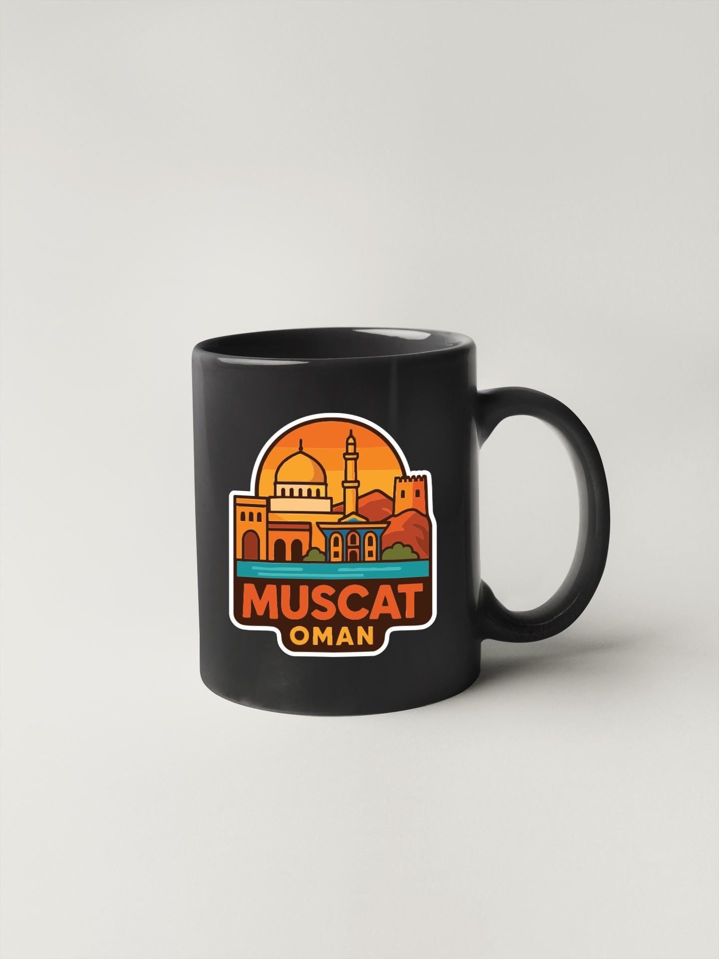 A black coffee mug with a graphic design featuring the city of Muscat, Oman.